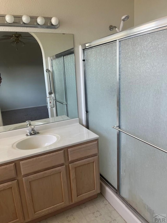 4706 Solar Dr, Pueblo, CO 81005 - full bathroom featuring vanity, a shower stall, a ceiling fan, and marble finish floor