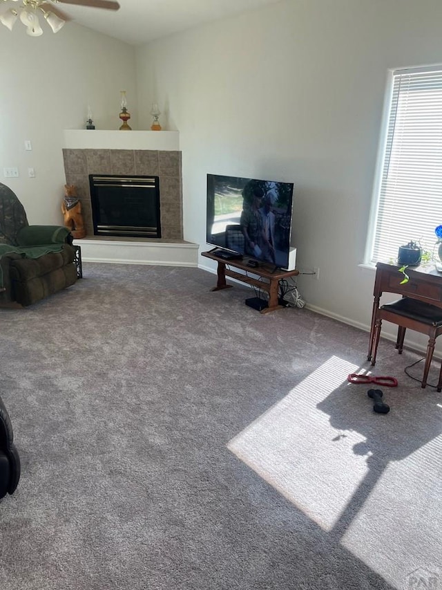 4706 Solar Dr, Pueblo, CO 81005 - carpeted living area with ceiling fan, vaulted ceiling, and a tiled fireplace