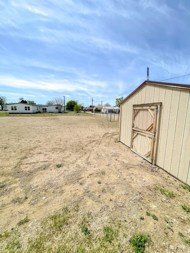 view of yard with a storage shed and an outdoor structure