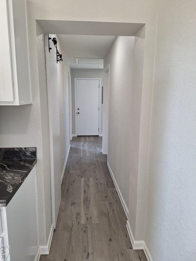 211 W Maplewood, Walsh, CO 81090 - hallway featuring wood finished floors and baseboards
