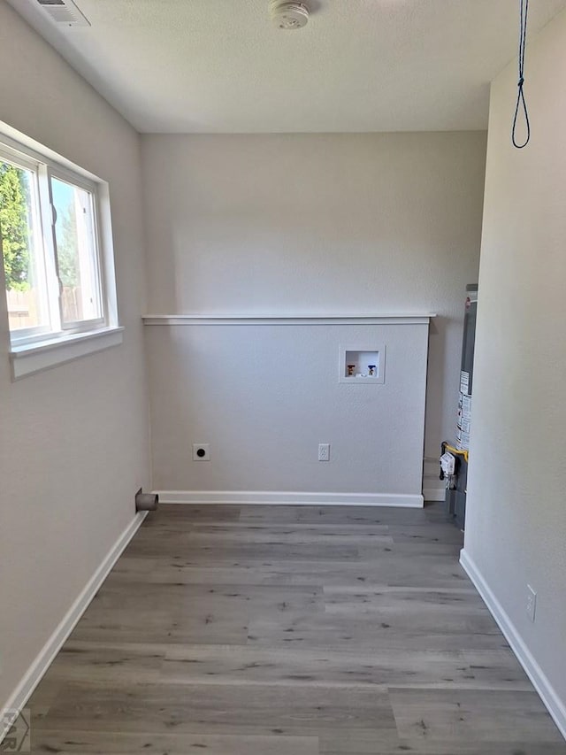 211 W Maplewood, Walsh, CO 81090 - laundry area featuring hookup for a washing machine, wood finished floors, electric dryer hookup, and baseboards