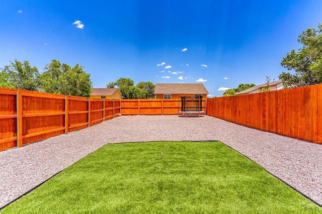 349-351 W Buttercup Way, Pueblo West, CO 81007 - fenced backyard with a trampoline