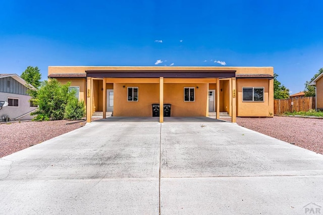 349-351 W Buttercup Way, Pueblo West, CO 81007 - view of front of home with a carport, driveway, and stucco siding