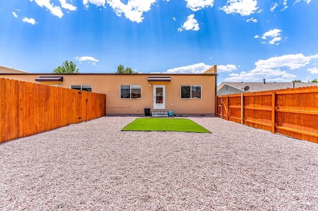 349-351 W Buttercup Way, Pueblo West, CO 81007 - rear view of property featuring a fenced backyard, stucco siding, and a patio