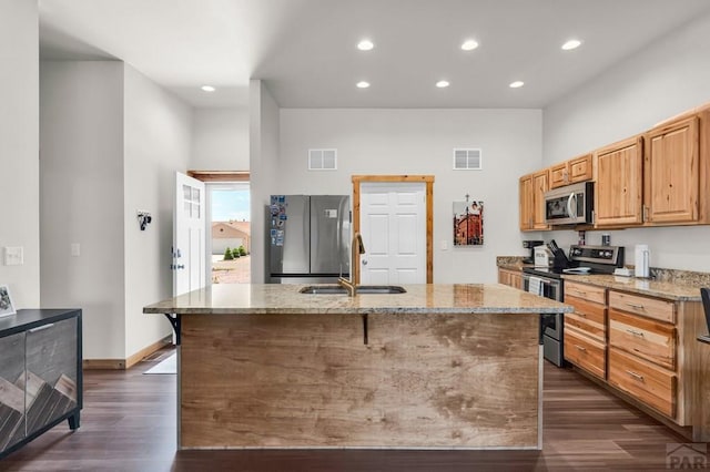 349-351 W Buttercup Way, Pueblo West, CO 81007 - kitchen featuring appliances with stainless steel finishes, dark wood-style flooring, light stone countertops, recessed lighting, and a towering ceiling