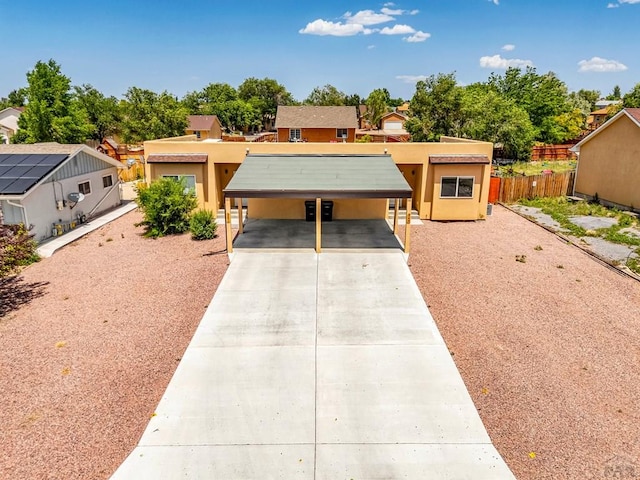 349-351 W Buttercup Way, Pueblo West, CO 81007 - pueblo revival-style home featuring driveway, stucco siding, and a carport