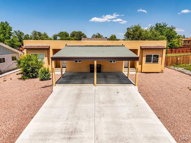 349-351 W Buttercup Way, Pueblo West, CO 81007 - view of front facade with a carport, driveway, and stucco siding