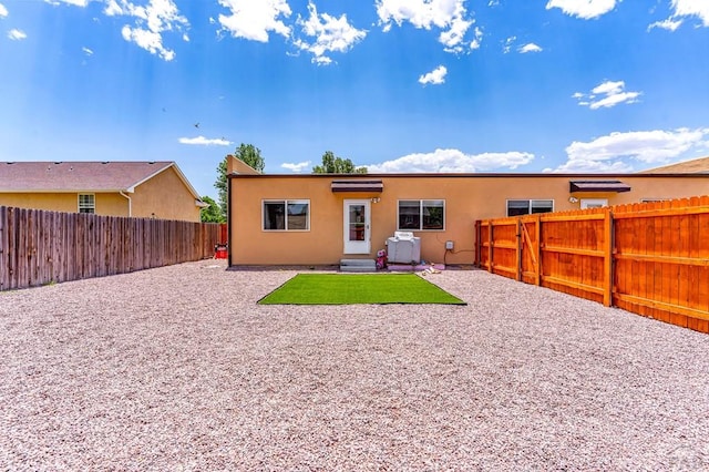 349-351 W Buttercup Way, Pueblo West, CO 81007 - rear view of house with a fenced backyard, stucco siding, and a patio area