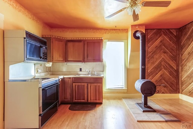 1708 Alta St, Trinidad, CO 81082 - kitchen with electric range, black microwave, light countertops, light wood finished floors, and ceiling fan