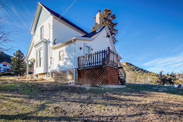 1708 Alta St, Trinidad, CO 81082 - view of side of home featuring a chimney, stairs, and a wooden deck