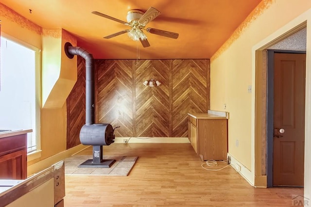 1708 Alta St, Trinidad, CO 81082 - unfurnished room featuring a ceiling fan, light wood-style floors, and a wood stove