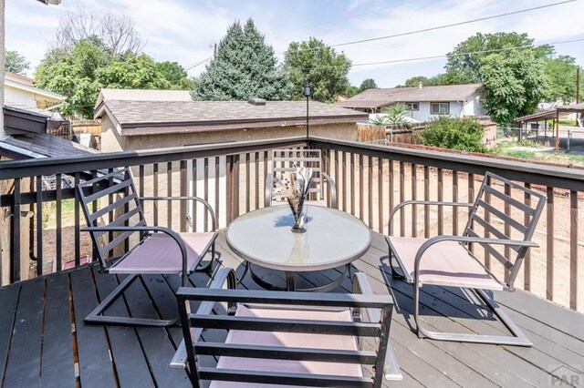 wooden deck with outdoor dining space and fence