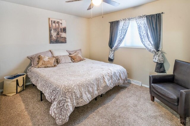 carpeted bedroom with ceiling fan, visible vents, and baseboards