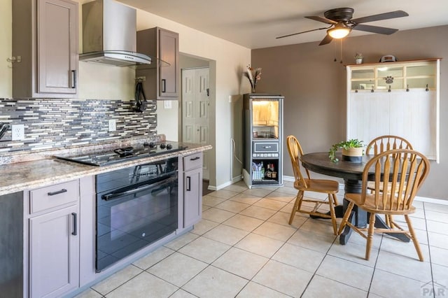 kitchen featuring black appliances, tasteful backsplash, ventilation hood, and light tile patterned flooring