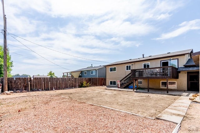 back of property featuring a patio, stucco siding, stairway, fence, and a wooden deck