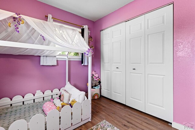 unfurnished bedroom featuring a closet and wood finished floors