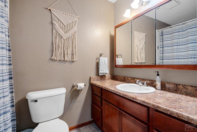 bathroom with tile patterned flooring, vanity, toilet, and a shower with curtain