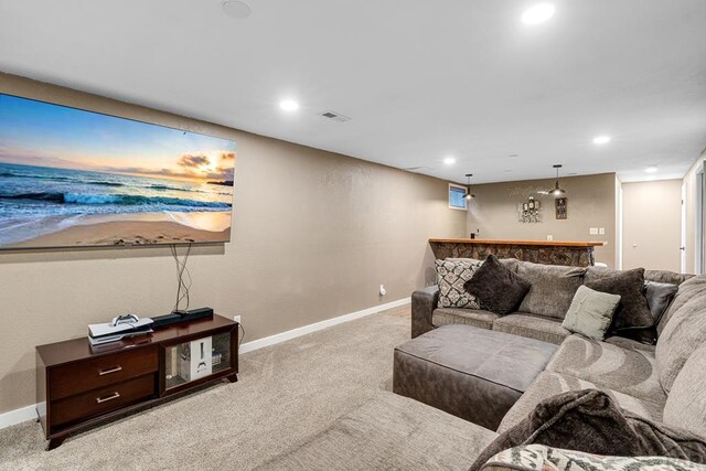 living room featuring baseboards, recessed lighting, visible vents, and light colored carpet