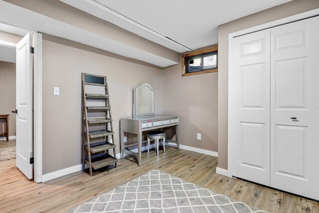 interior space with wood finished floors and baseboards