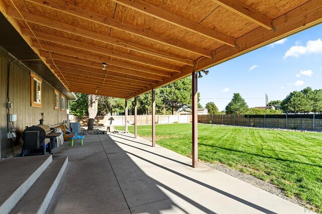 view of patio featuring a fenced backyard and a grill