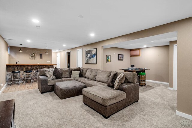 living area featuring a dry bar, baseboards, and recessed lighting