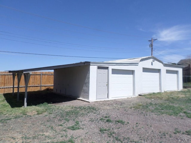garage with fence and a garage