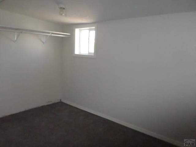 interior space featuring dark colored carpet