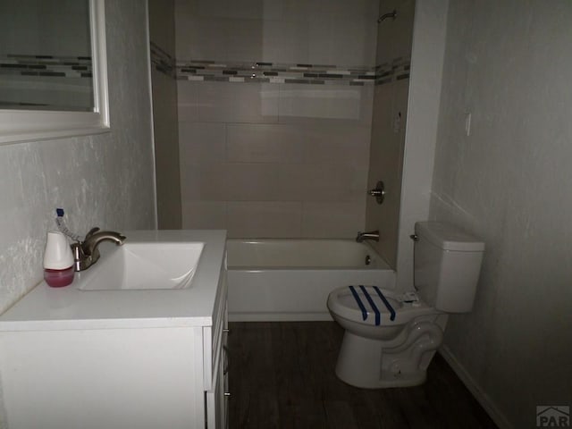 bathroom with vanity, bathtub / shower combination, toilet, and wood finished floors