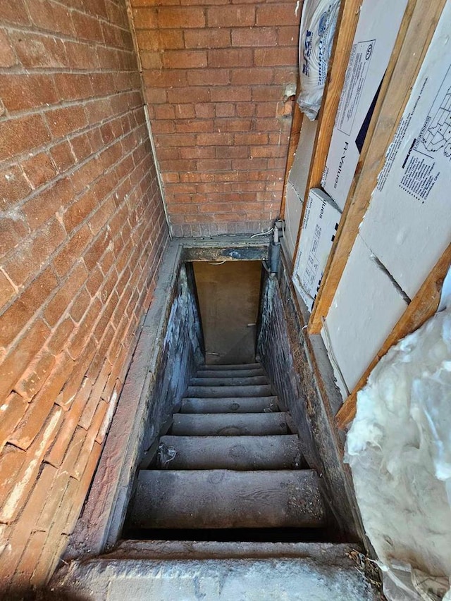 stairway with brick wall