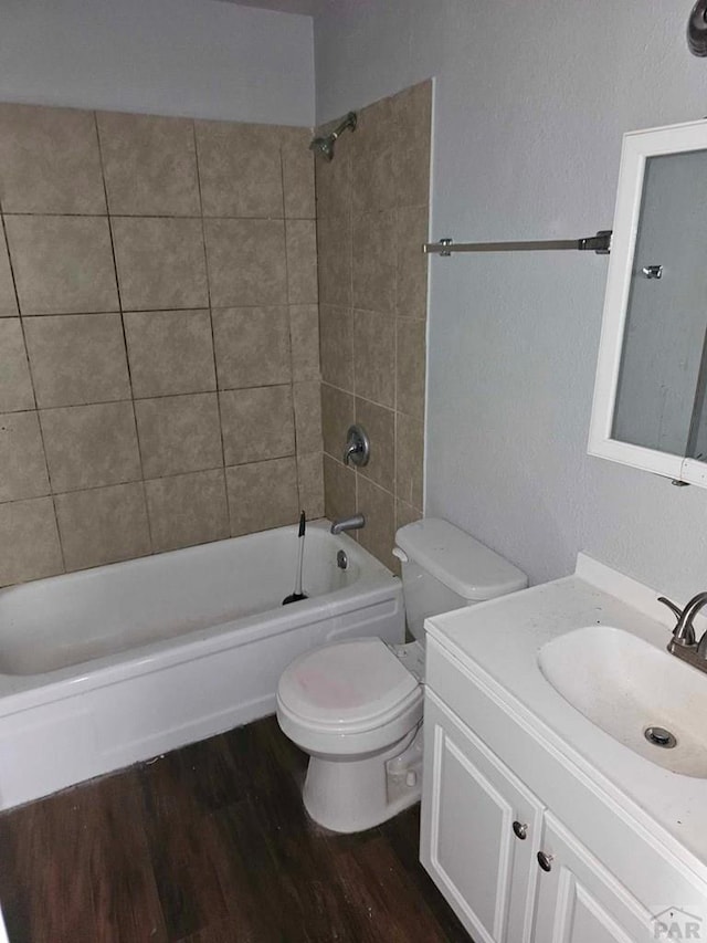 bathroom featuring bathtub / shower combination, vanity, toilet, and wood finished floors