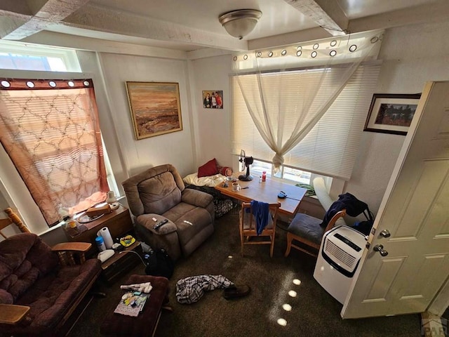 living area featuring carpet floors and beamed ceiling