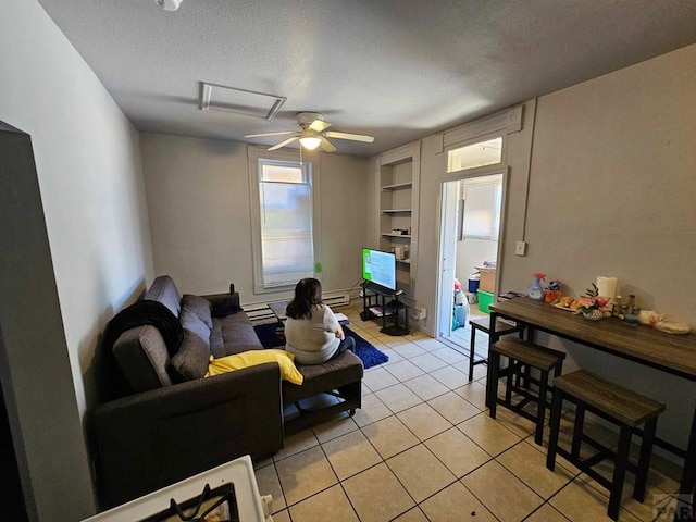 living area with light tile patterned floors, ceiling fan, a textured ceiling, and built in features