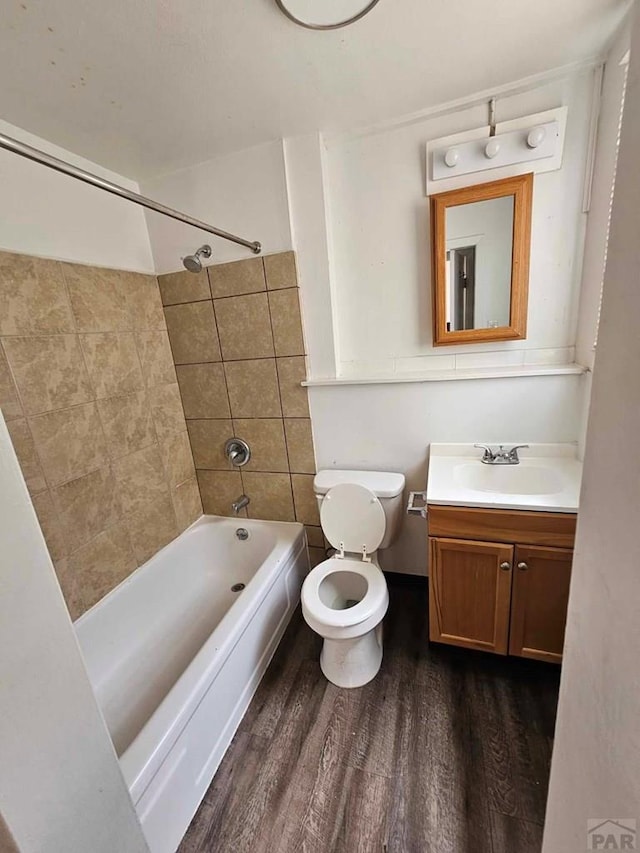 full bathroom featuring vanity, tub / shower combination, wood finished floors, and toilet