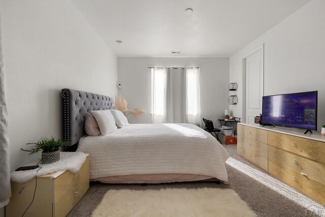 bedroom featuring light carpet and visible vents