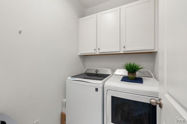 laundry room featuring cabinet space and washing machine and dryer