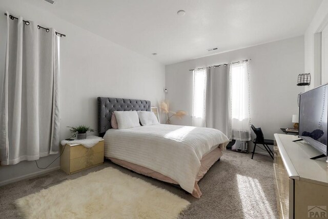 bedroom with visible vents and light colored carpet