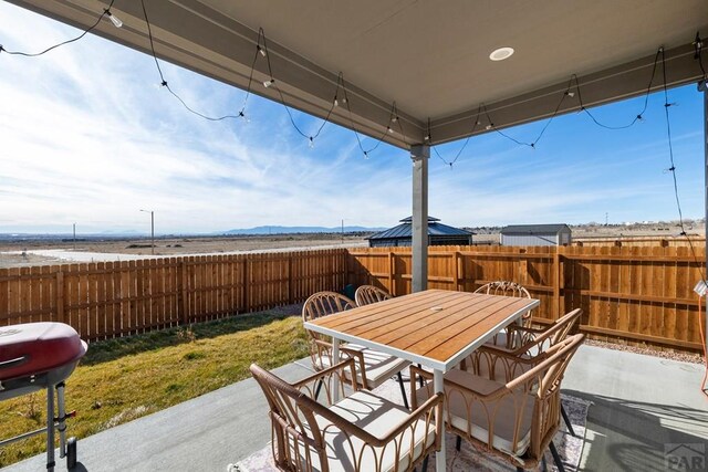 view of patio / terrace featuring outdoor dining space, grilling area, and a fenced backyard