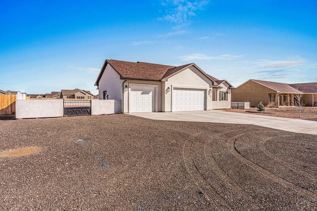 ranch-style home featuring an attached garage, fence, driveway, a residential view, and stucco siding