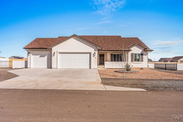 ranch-style house with a garage, a shingled roof, concrete driveway, fence, and stucco siding