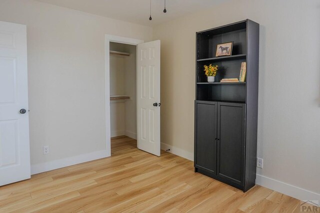1709 Henry Ave, Pueblo, CO 81005 - unfurnished bedroom with light wood-type flooring, baseboards, and a closet