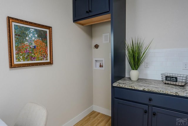 1709 Henry Ave, Pueblo, CO 81005 - washroom with washer hookup, light wood finished floors, cabinet space, and baseboards