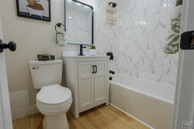 1709 Henry Ave, Pueblo, CO 81005 - bathroom with wood finished floors, toilet, vanity, and bathing tub / shower combination