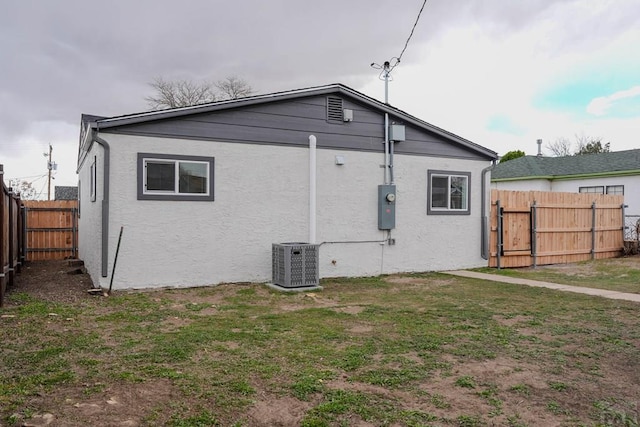 1709 Henry Ave, Pueblo, CO 81005 - back of property featuring cooling unit, a gate, and stucco siding
