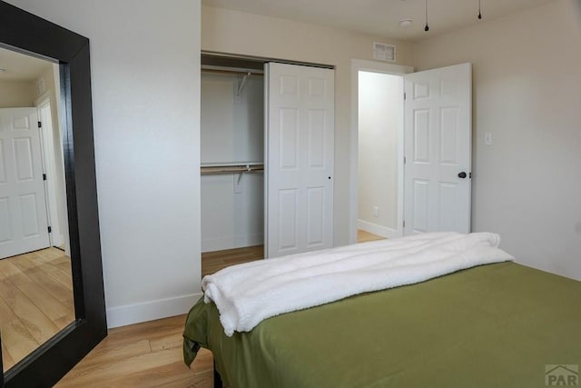 1709 Henry Ave, Pueblo, CO 81005 - bedroom with a closet, baseboards, and light wood-style floors