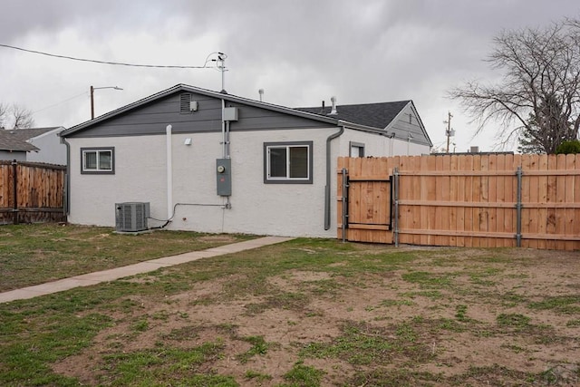 1709 Henry Ave, Pueblo, CO 81005 - back of property with a gate, central AC, and stucco siding