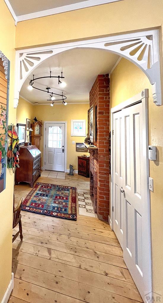 134 E Virginia Ave, La Veta, CO 81055 - entryway with hardwood / wood-style floors, crown molding, and arched walkways