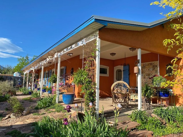 134 E Virginia St, La Veta, CO 81055 - rear view of house featuring stucco siding and a patio