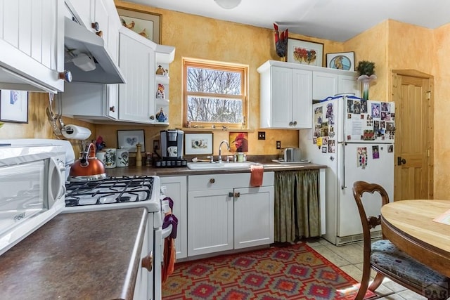 134 E Virginia Ave, La Veta, CO 81055 - kitchen featuring white cabinets, a sink, white appliances, under cabinet range hood, and light tile patterned flooring