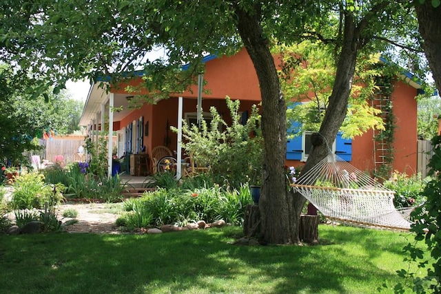 134 E Virginia Ave, La Veta, CO 81055 - rear view of property with a yard and stucco siding
