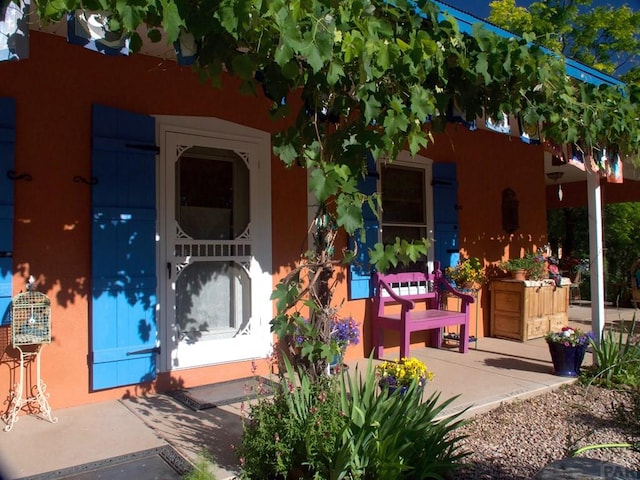 134 E Virginia Ave, La Veta, CO 81055 - doorway to property featuring stucco siding